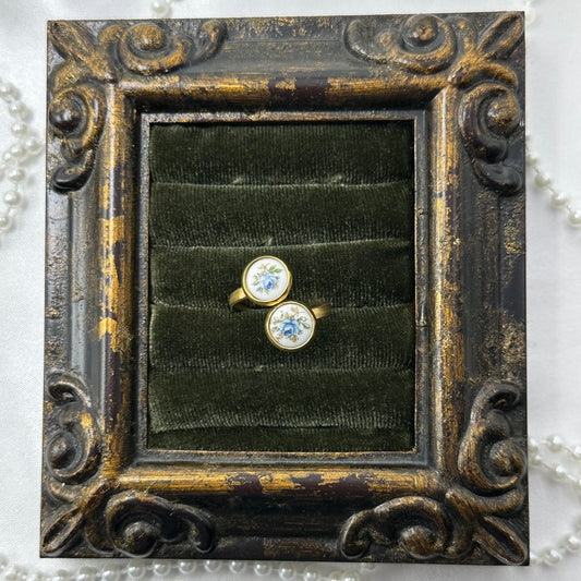 Vintage style gold tone bypass ring with round blue rose painted white enamel cameos.