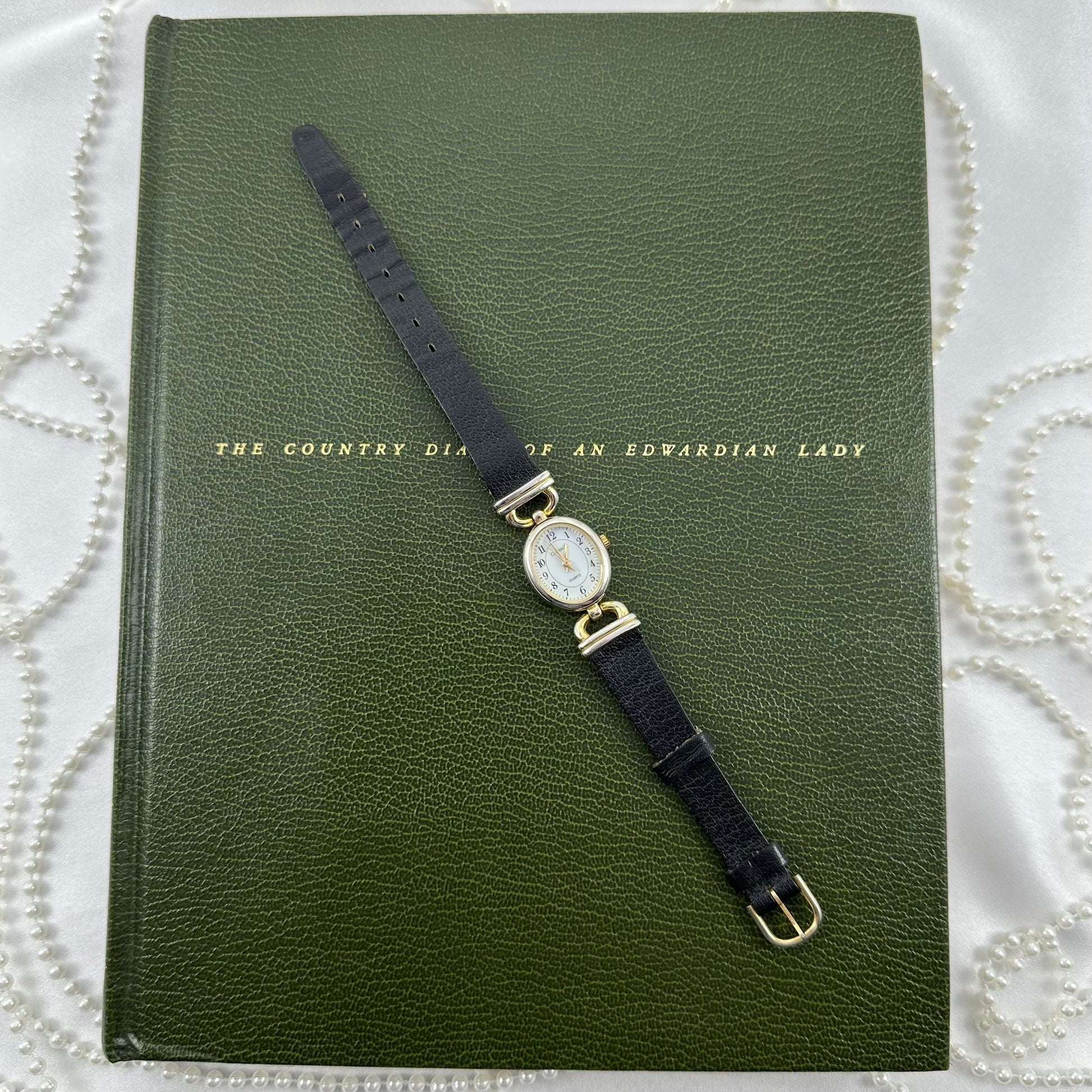 Vintage gold tone Carriage watch with genuine leather black band and oval dial.