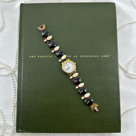 Rare vintage gold tone watch with bowling balls and bowling pin slide charm band and round mother of pearl dial.