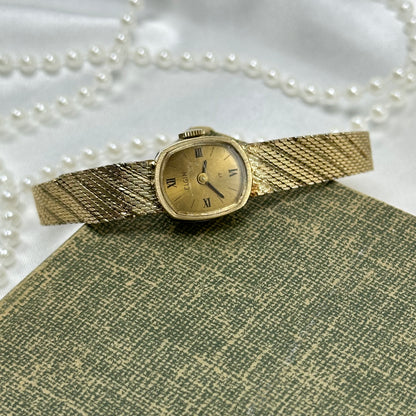 Slender Gold Vintage Wind-Up Elgin Watch with Roman Numeral Markers