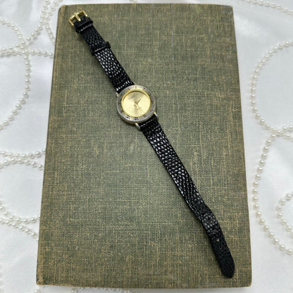 Gold Round Dial Watch with Roman Numeral Markers