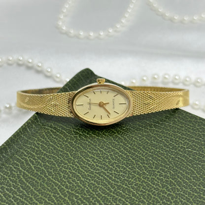 Slender Gold Armitron Watch with Oval Dial and Floral Band