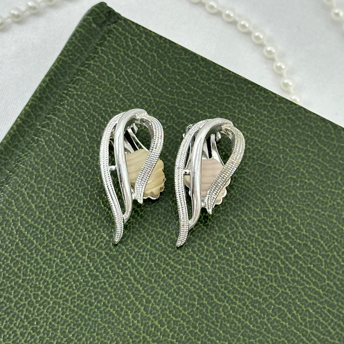 Vintage silver tone Sarah Coventry clip on earrings from 1958.