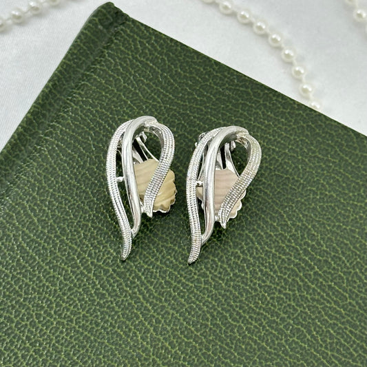 Vintage silver tone Sarah Coventry clip on earrings from 1958.
