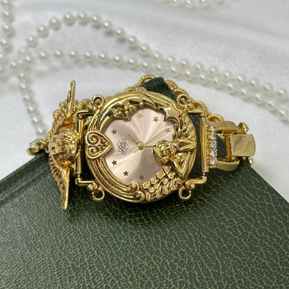 Vintage gold tone rare Kirks Folly watch with whimsical, celestial angel round dial and chain band.