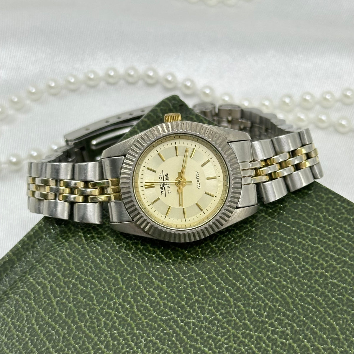 Vintage silver and gold tone Waltham Prestige tank watch with champagne dial and metal two-tone band from the 1990's.