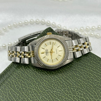 Vintage silver and gold tone Waltham Prestige tank watch with champagne dial and metal two-tone band from the 1990's.