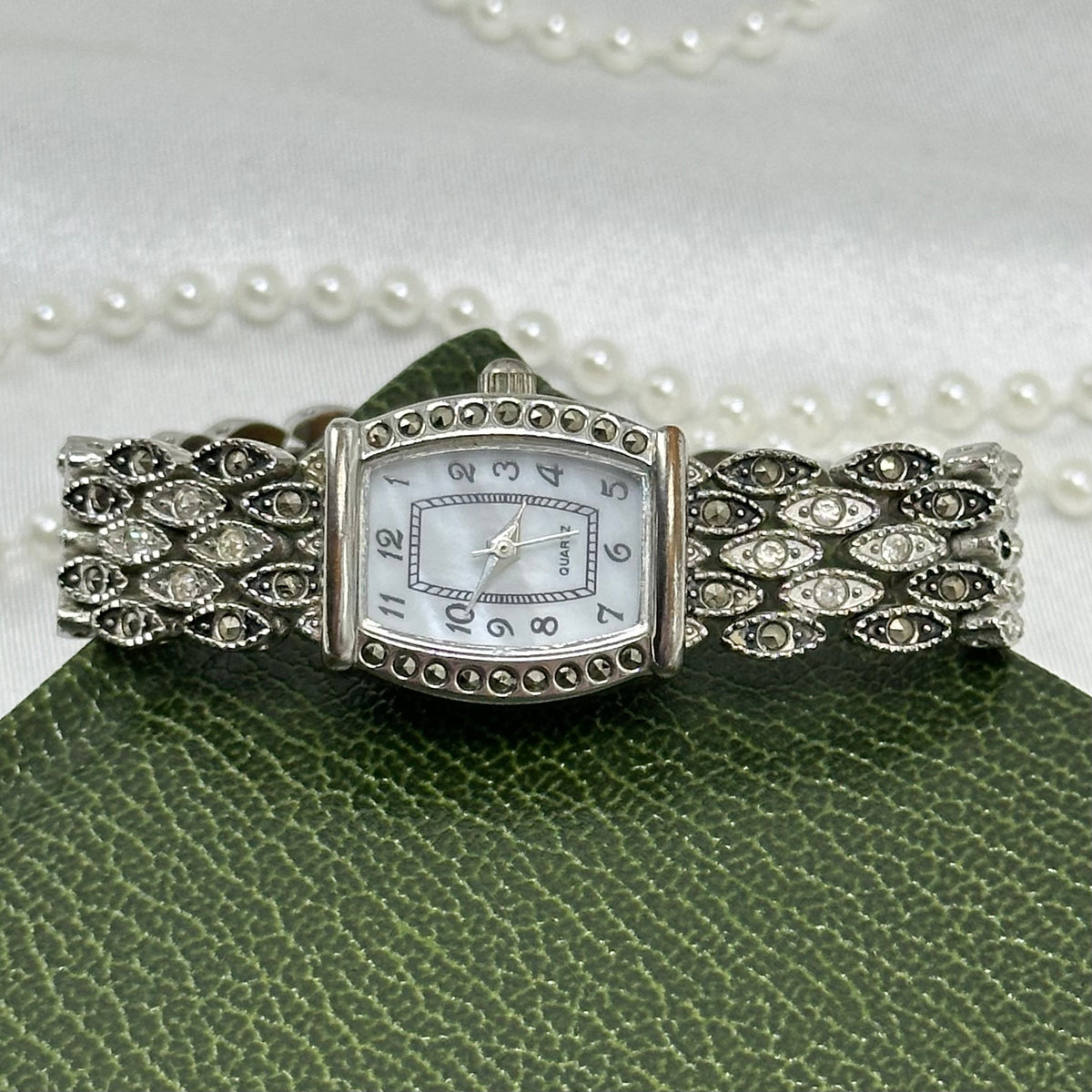 Vintage silver and black tone watch with rectangular mother of pearl dial and marcasite.