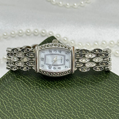 Vintage silver and black tone watch with rectangular mother of pearl dial and marcasite.