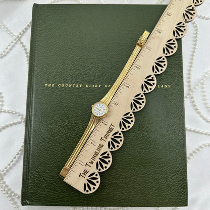 Slender Gold Armitron Watch with Round Dial
