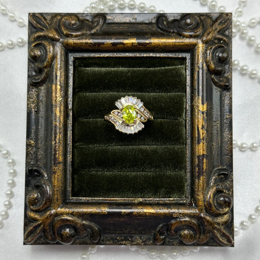 14k gold electroplated vintage art deco style deadstock ring with light green CZ center stone surrounded by clear cubic zirconia stones.
