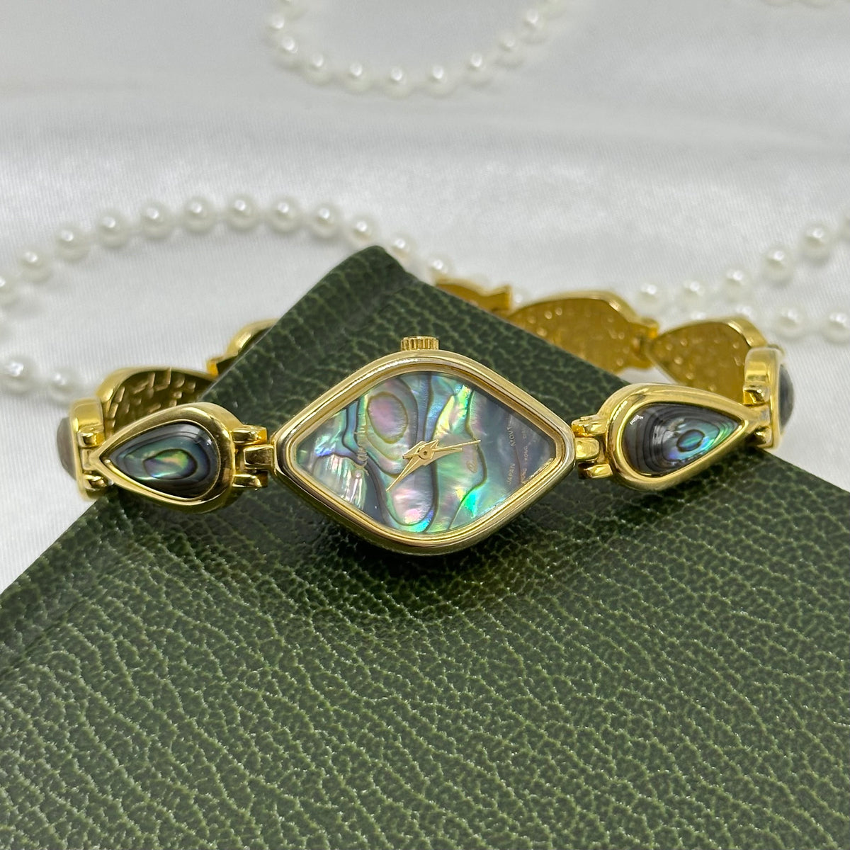 Vintage gold tone Xandu watch with abalone diamond shaped dial and abalone band.