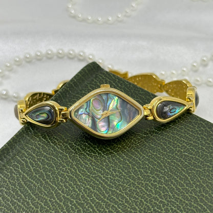 Vintage gold tone Xandu watch with abalone diamond shaped dial and abalone band.