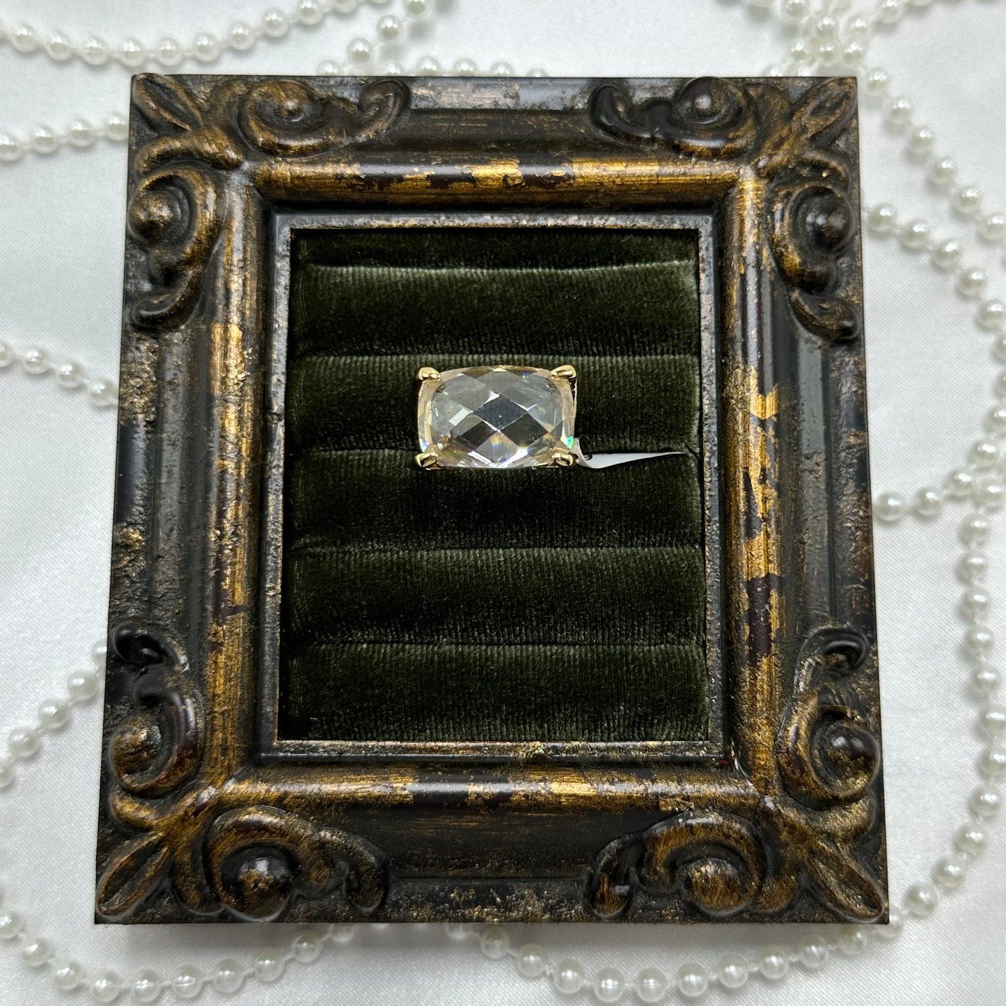 14k gold electroplated vintage deadstock ring with large clear stone and cubic zirconia stones on the side.