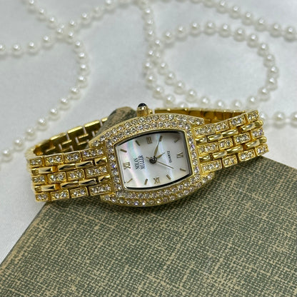 Elegant Crystal Gold Nolan Miller Watch with Mother of Pearl Dial