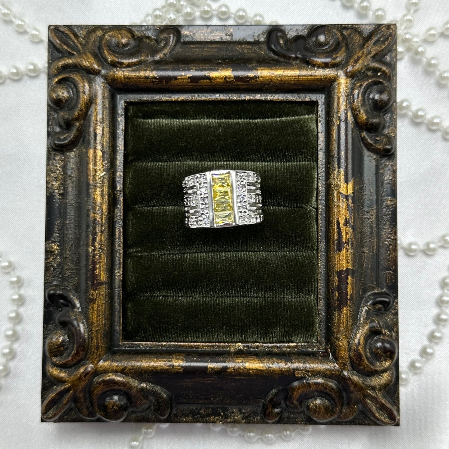 Rhodium plated vintage deadstock band ring with 3 rows of clear and yellow cubic zirconia stones.