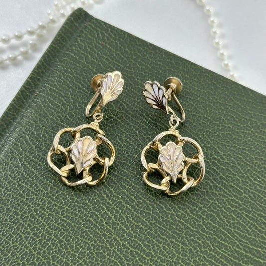 Vintage gold tone clip on screw back dangle earrings with two-tone leaves.