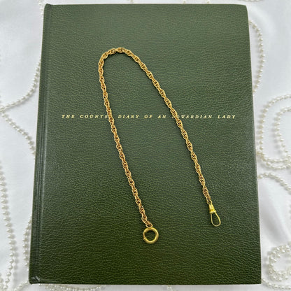 Vintage gold tone twisted metal watch chain with dog clip clasp from the 1960's.