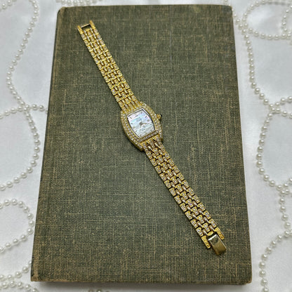 Elegant Crystal Gold Nolan Miller Watch with Mother of Pearl Dial