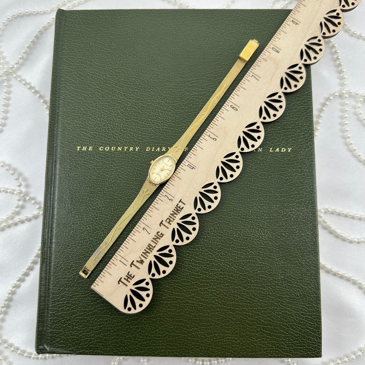 Slender Gold Armitron Watch with Oval Dial and Floral Band