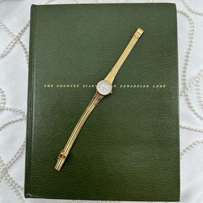 Slender Gold Armitron Watch with Round Dial