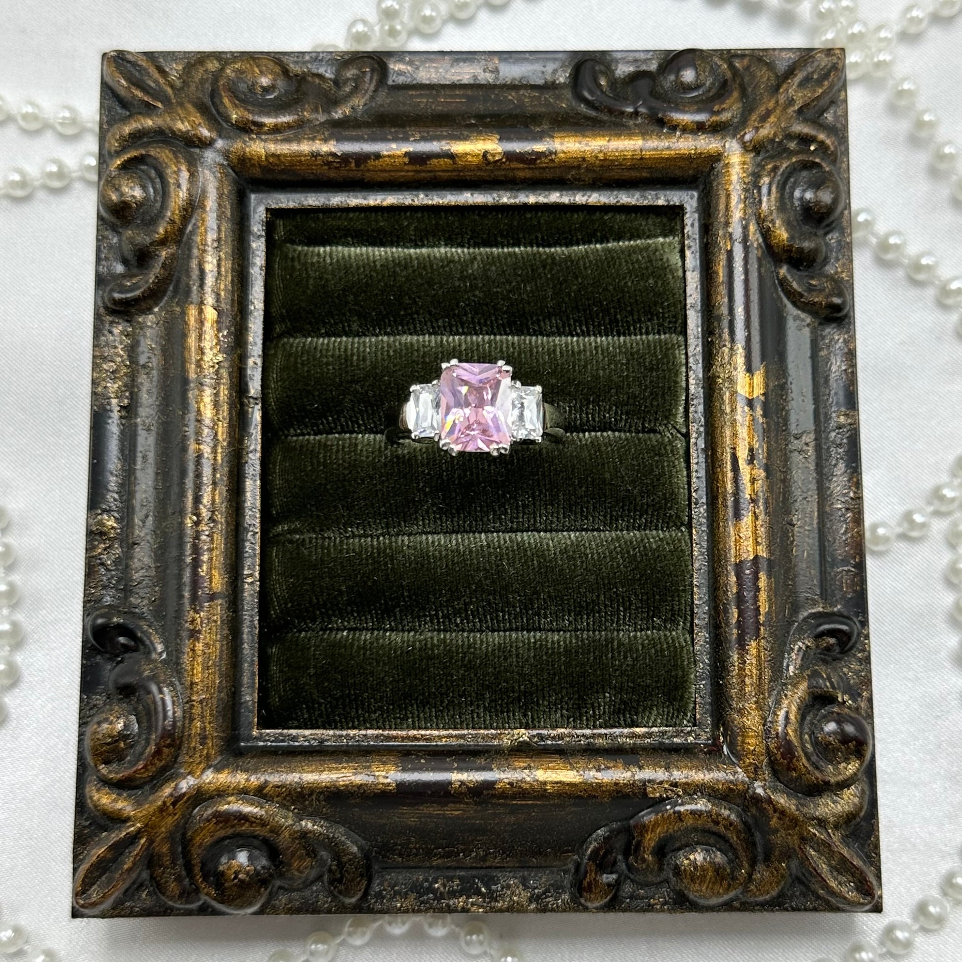 Rhodium plated vintage deadstock ring with large pink square shaped center stone surrounded by cubic zirconia stones