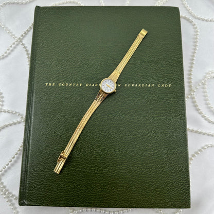 Slender Gold Armitron Watch with Round Dial