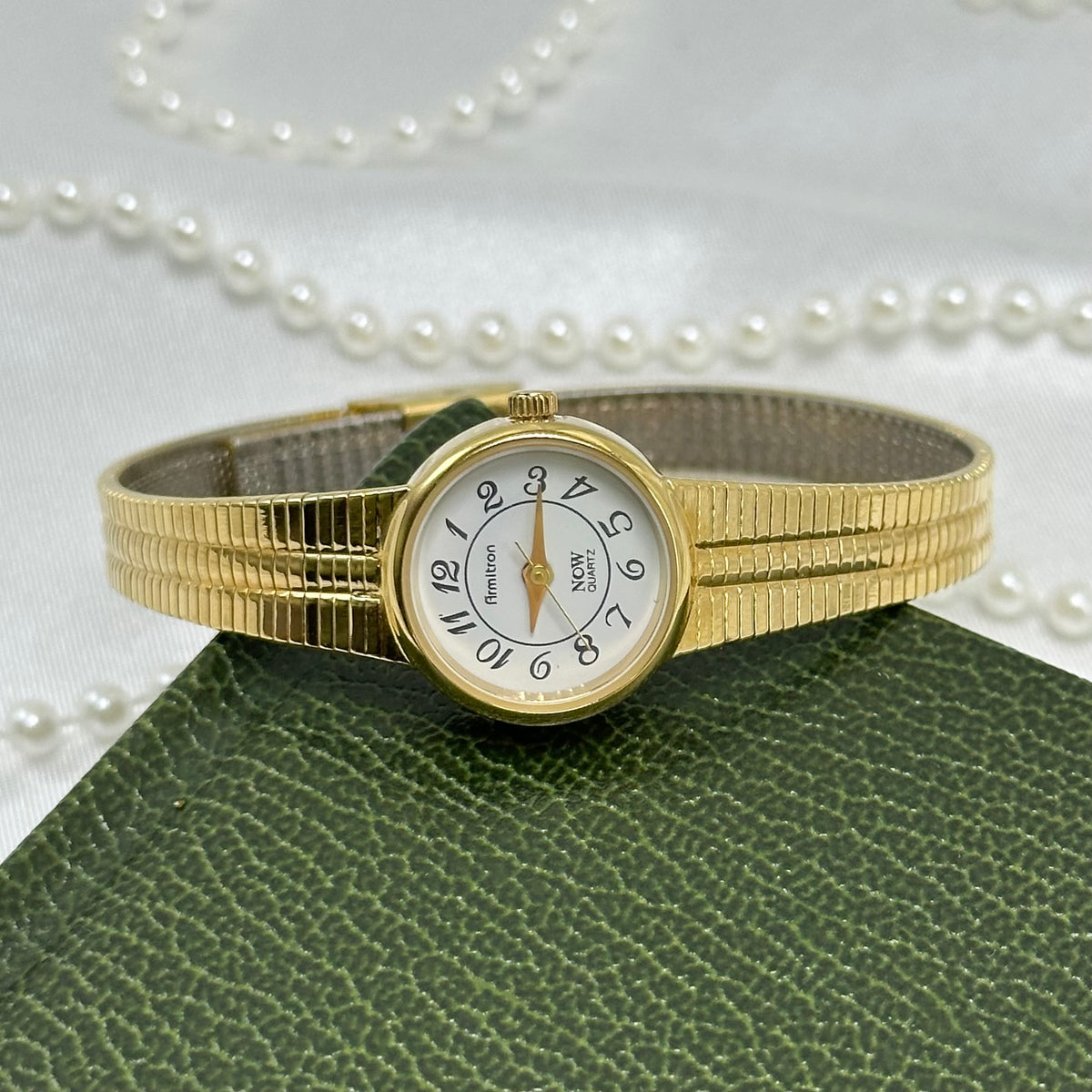 Slender Gold Armitron Watch with Round Dial