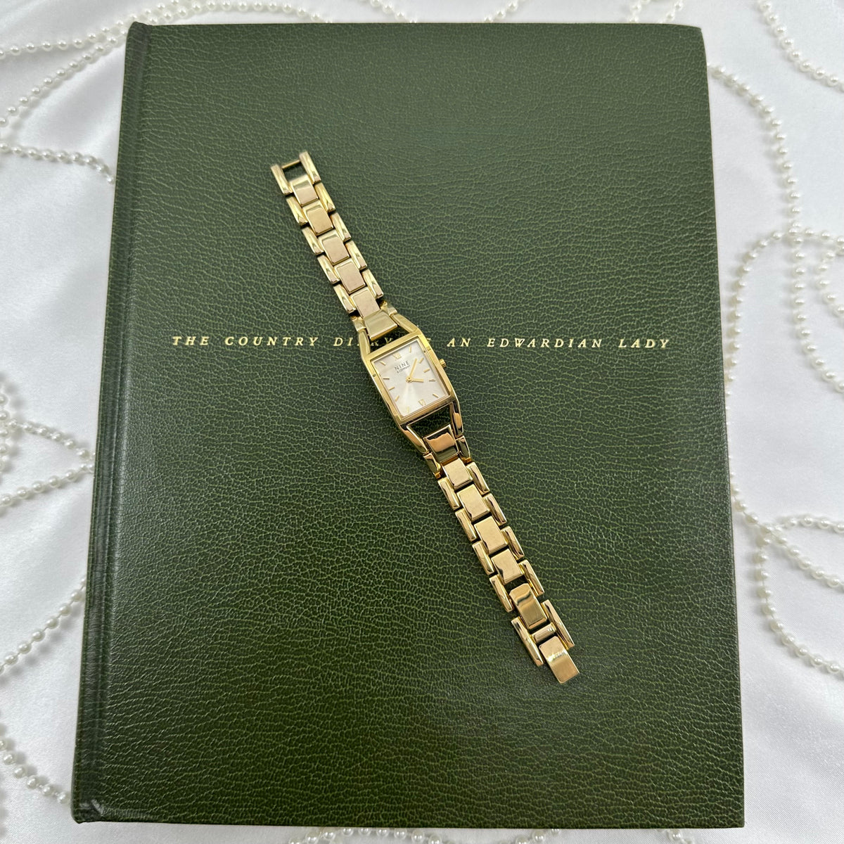 Classic Gold Nine & Company Watch with Rectangular Dial