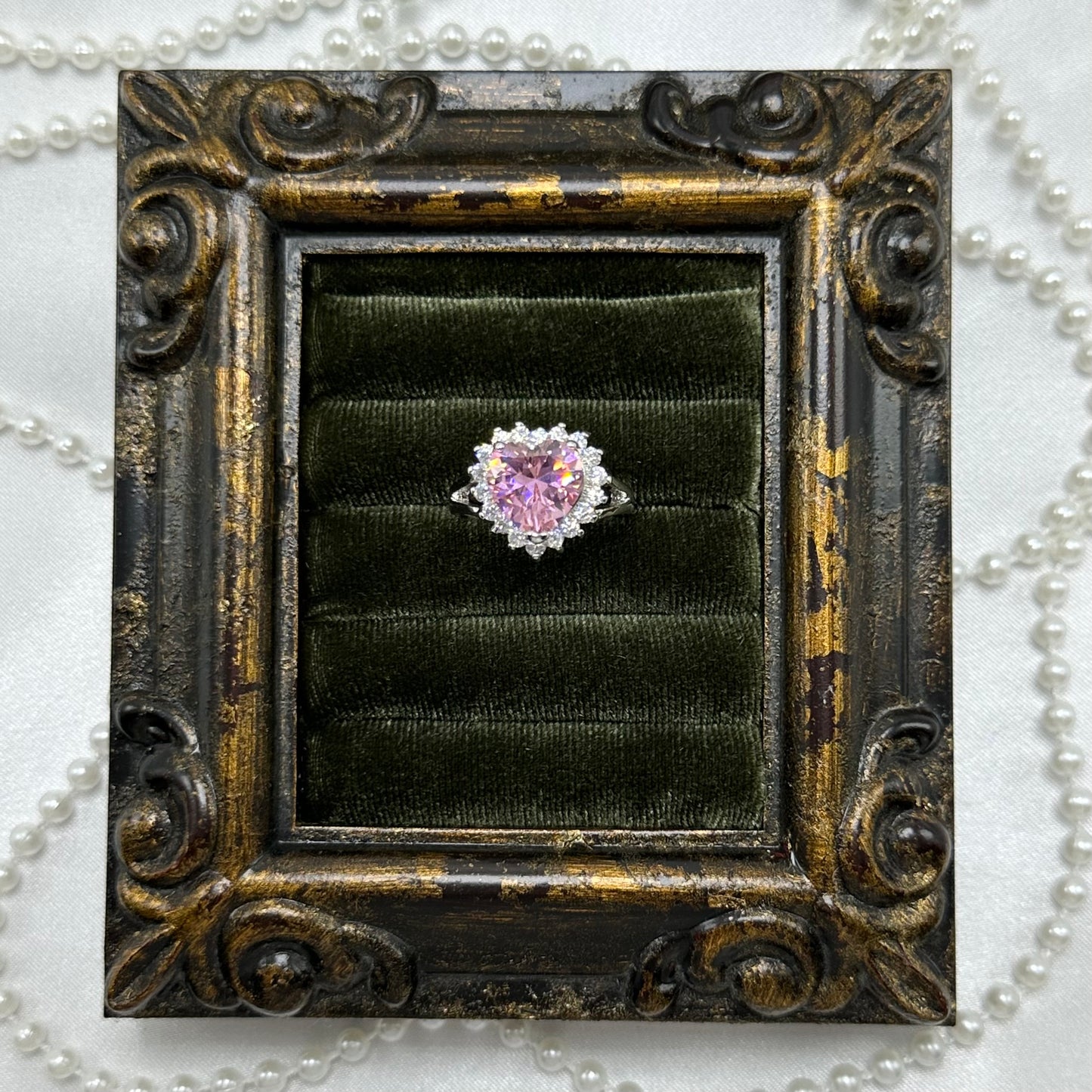 Rhodium plated vintage deadstock ring with large pink heart shaped center stone surrounded by cubic zirconia stones.