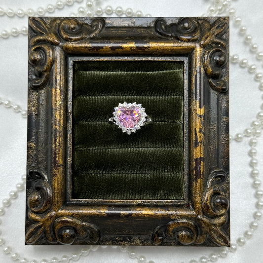 Rhodium plated vintage deadstock ring with large pink heart shaped center stone surrounded by cubic zirconia stones.