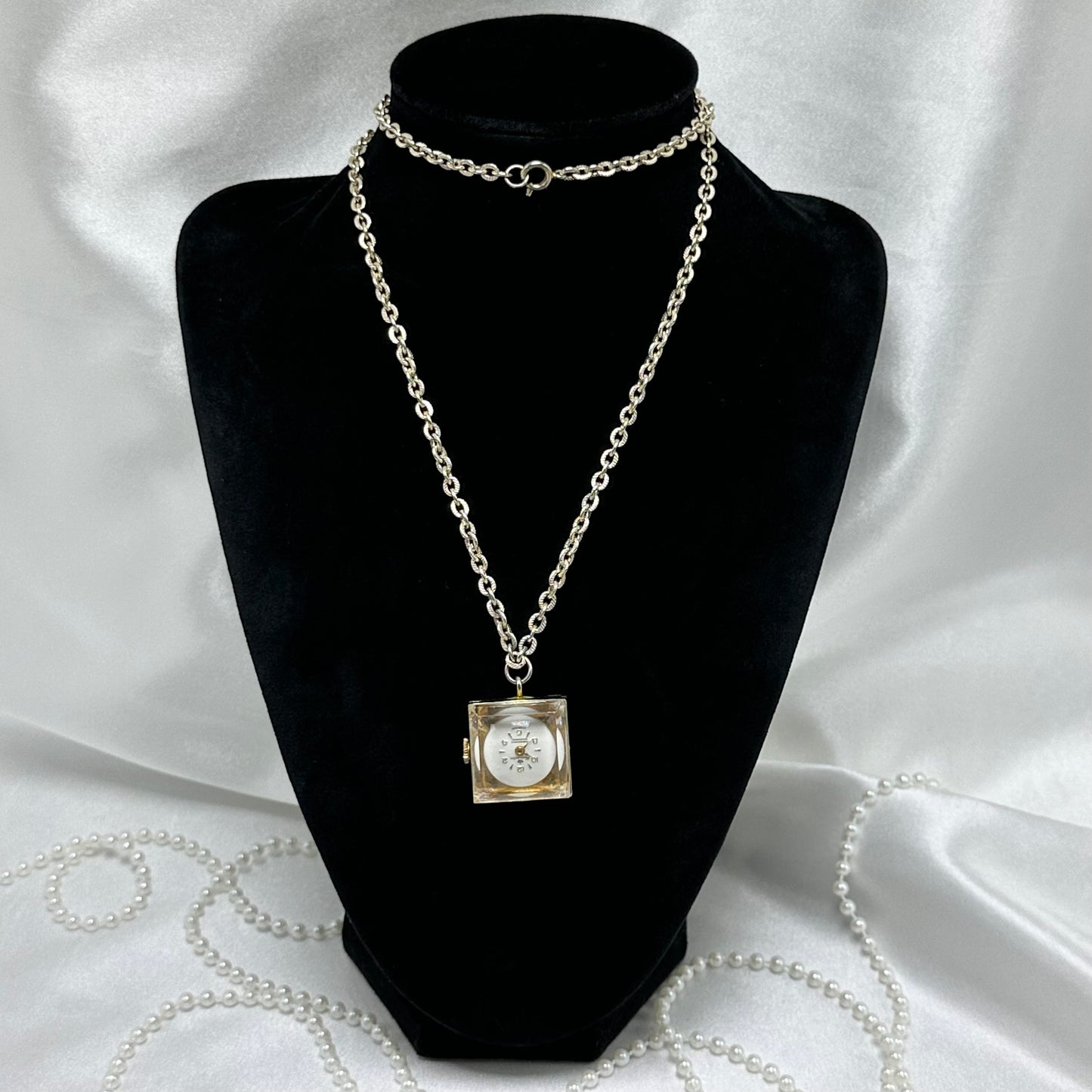 Vintage Harvester Swiss made manual winding watch necklace with a unique square "ice cube" style case and see through back.