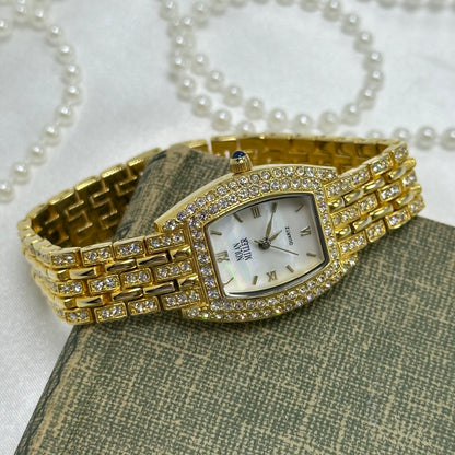 Elegant Crystal Gold Nolan Miller Watch with Mother of Pearl Dial