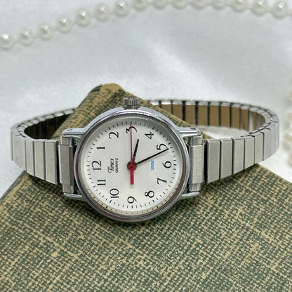 Vintage silver tone classic round dial Timex watch with stretchable band and quartz movement. Water resistant.
