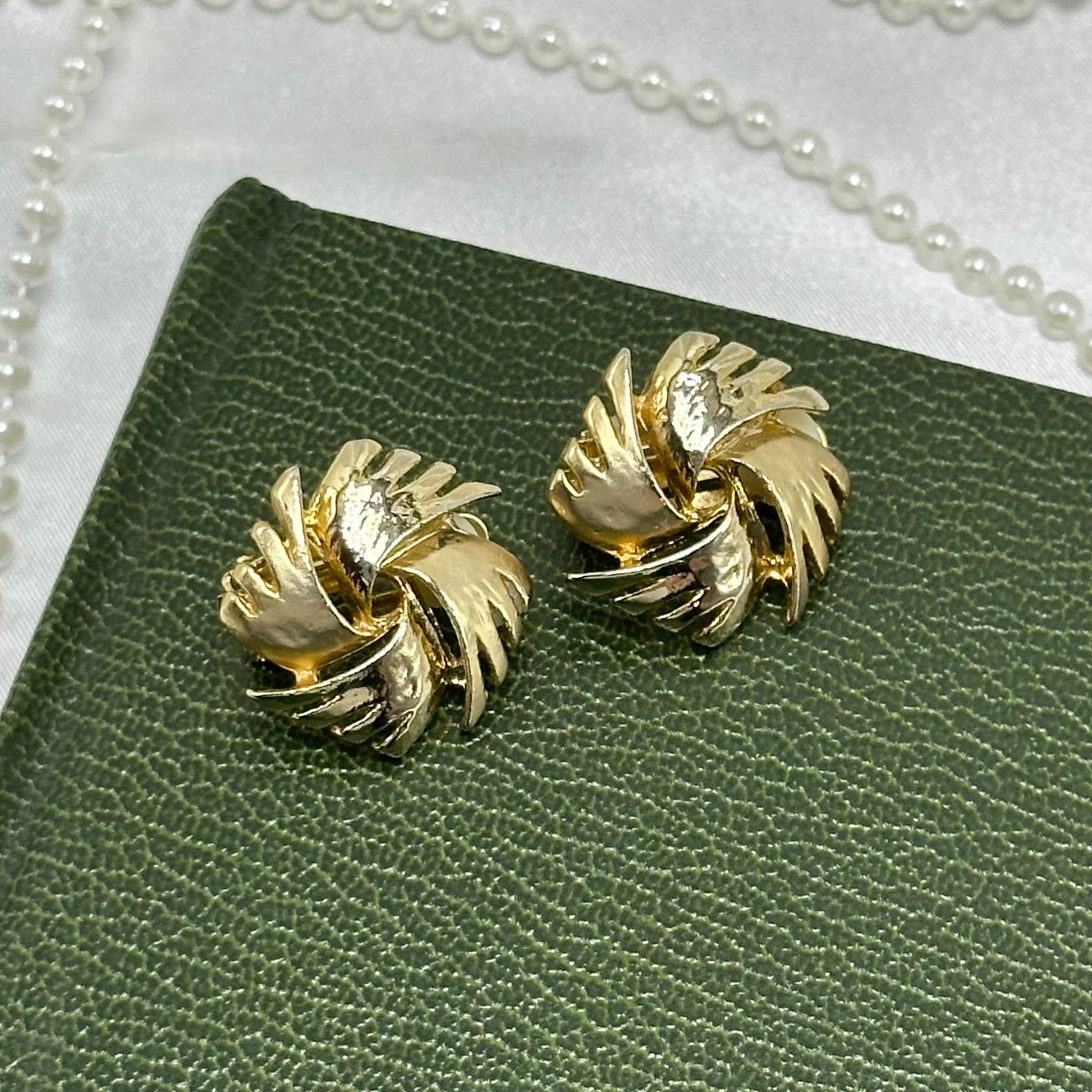 Vintage chunky gold tone starburst swirl clip on earrings made in the 1980's.
