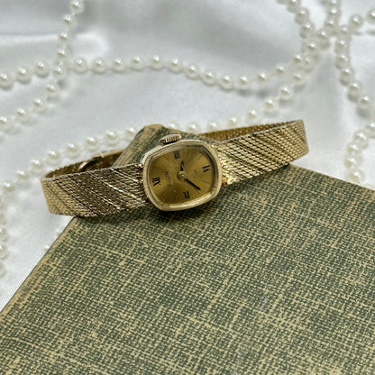 Slender Gold Vintage Wind-Up Elgin Watch with Roman Numeral Markers