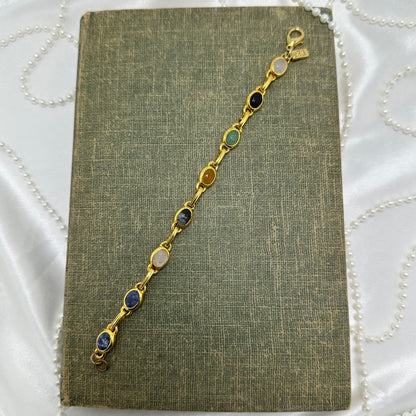 Dainty vintage gold tone bracelet with multicolor scarabs.