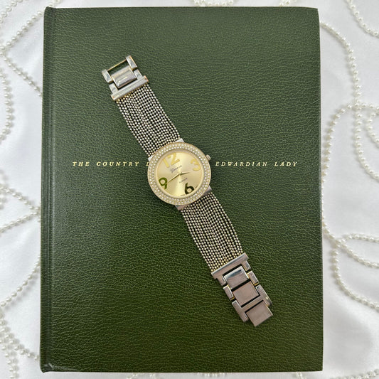 Vintage gold tone Geneva watch with large round dial and beaded chain bracelet band.
