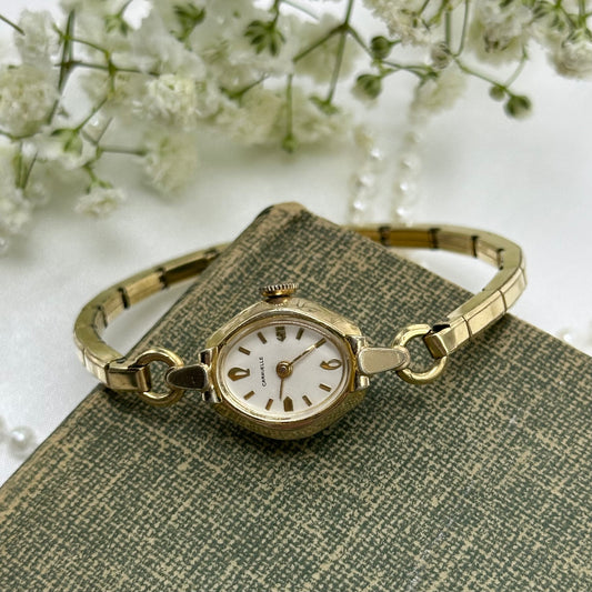 Vintage gold tone Caravelle manual winding watch with stretchable band from the 1960's. Watch comes with original C crown