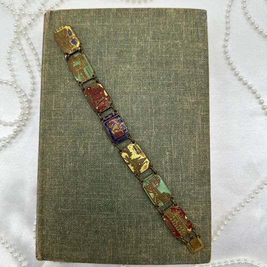 Antique brass French enamel souvenir bracelet. Metal panel links with colored enamel. Eiffel tour, arc de triomphe, trocadero, notre dame, sacre court.