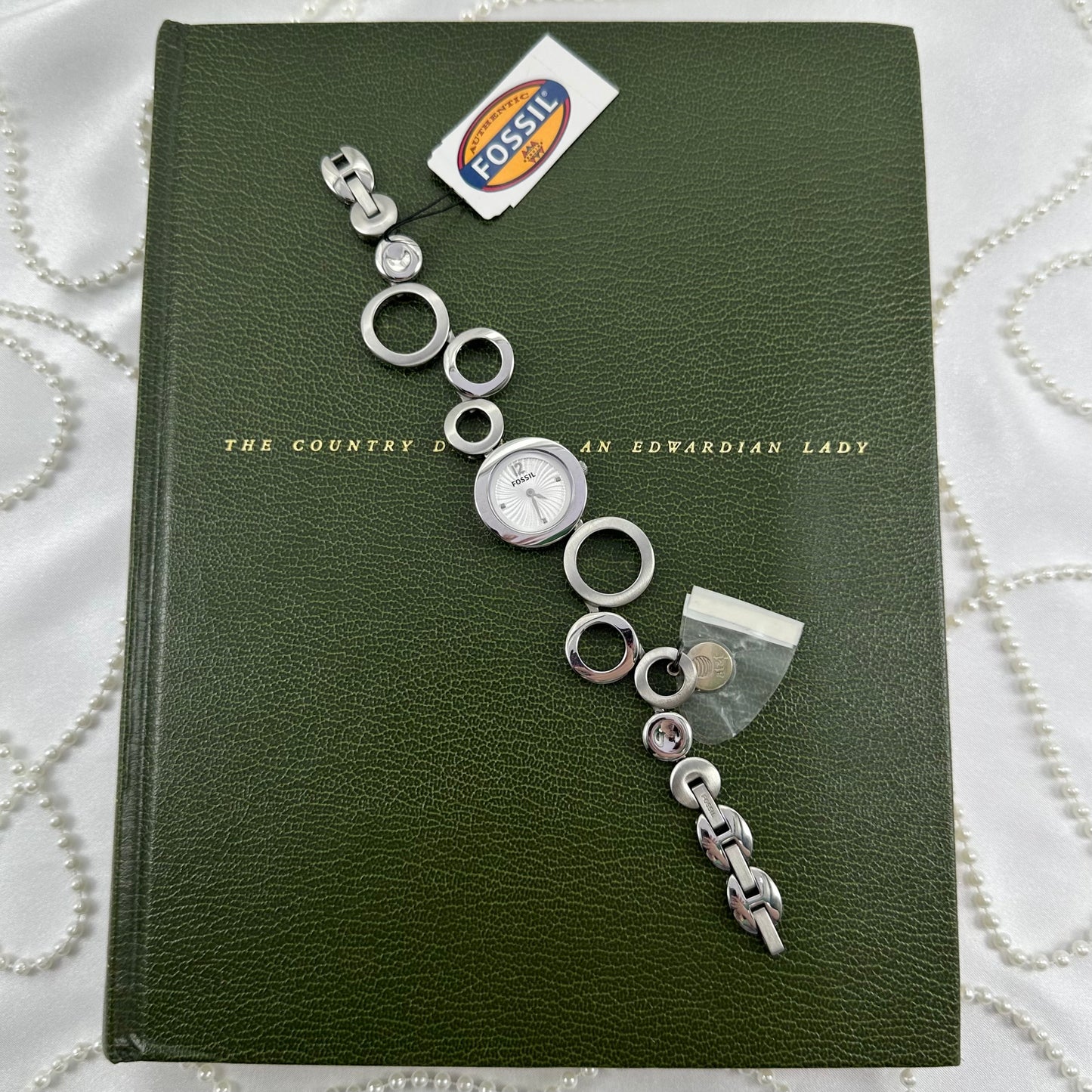 Vintage silver tone Fossil watch with round dial and unique geometric abstract circle band. Never worn with tags.
