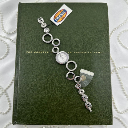 Vintage silver tone Fossil watch with round dial and unique geometric abstract circle band. Never worn with tags.