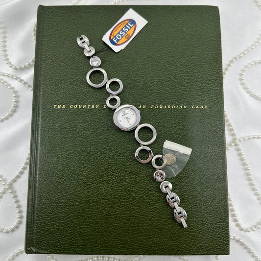 Vintage silver tone Fossil watch with round dial and unique geometric abstract circle band. Never worn with tags.