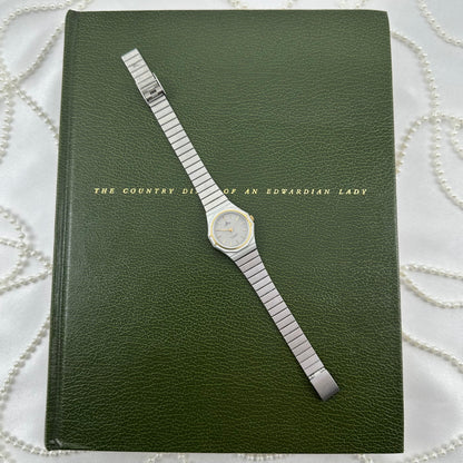 Vintage silver tone octagon case Lorus watch with a gold tone bezel accent and an stainless steel link bracelet.