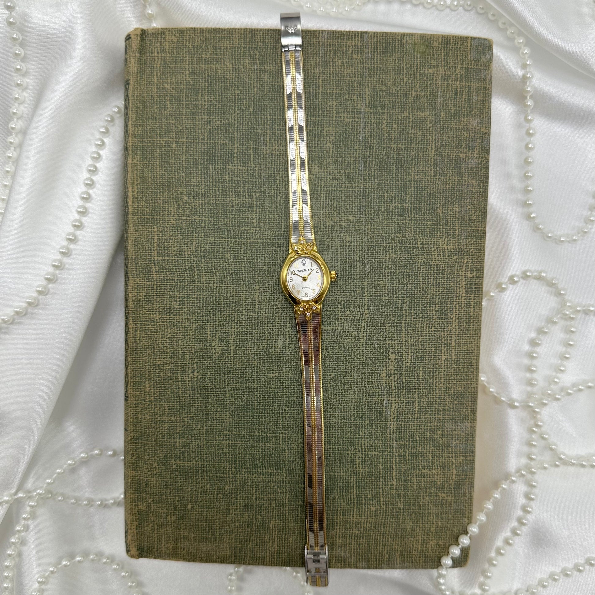 Two-tone Waltham watch with green jewel crown