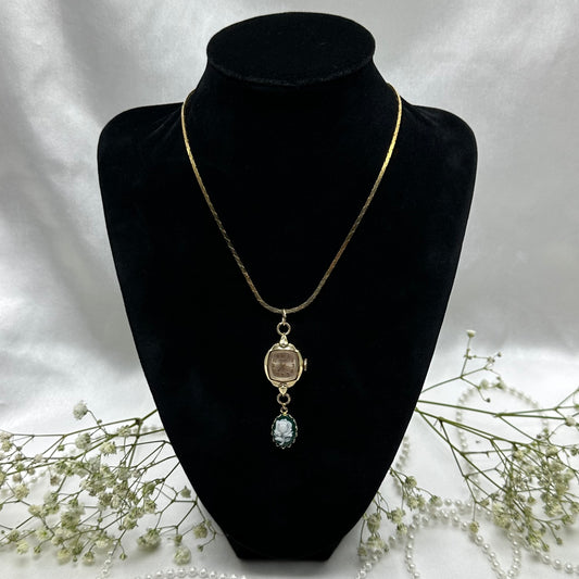 Gold tone necklace with vintage Timex watch and green rose cameo pendant on a cobra link chain.