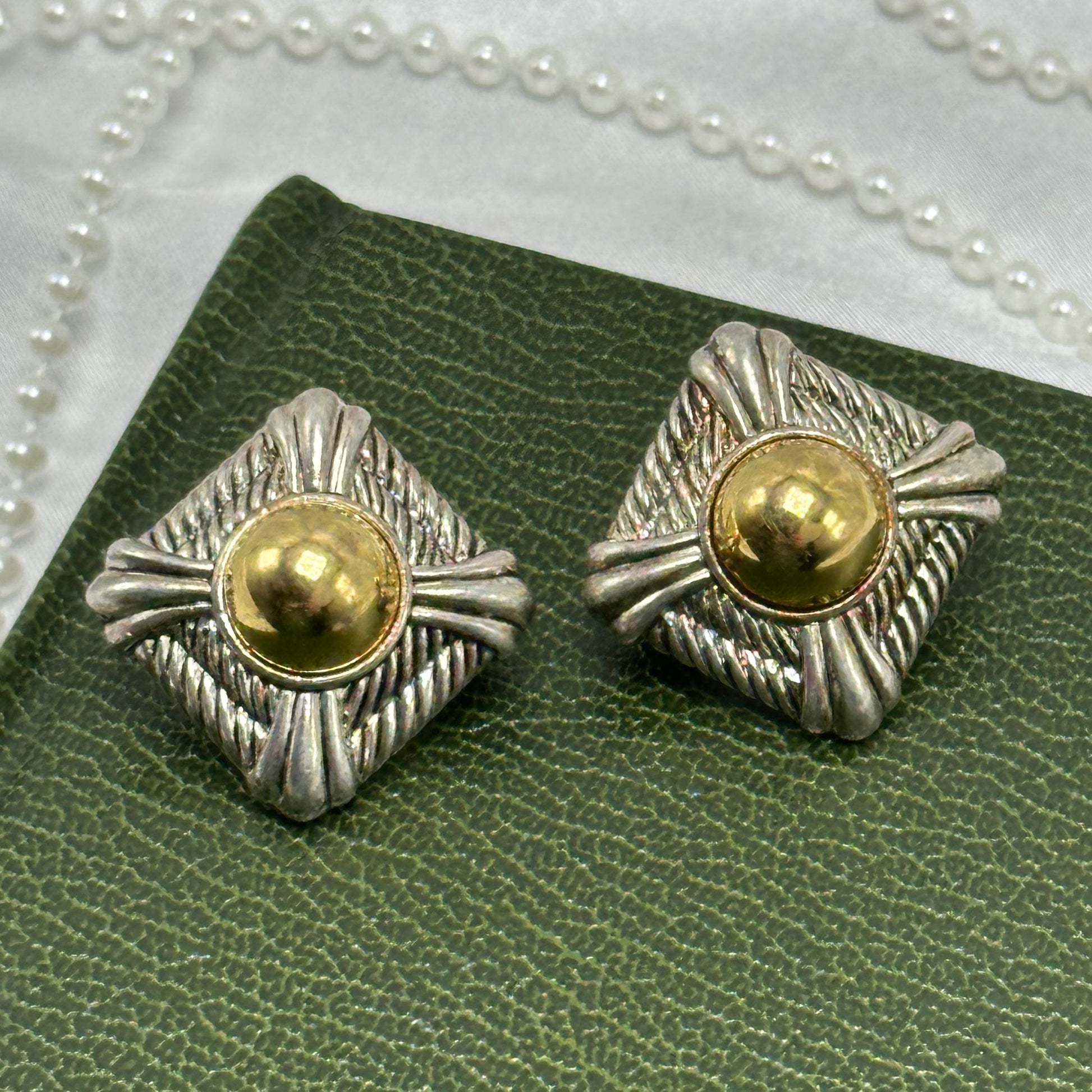 Vintage silver and gold tone diamond shaped Avon clip on earrings.