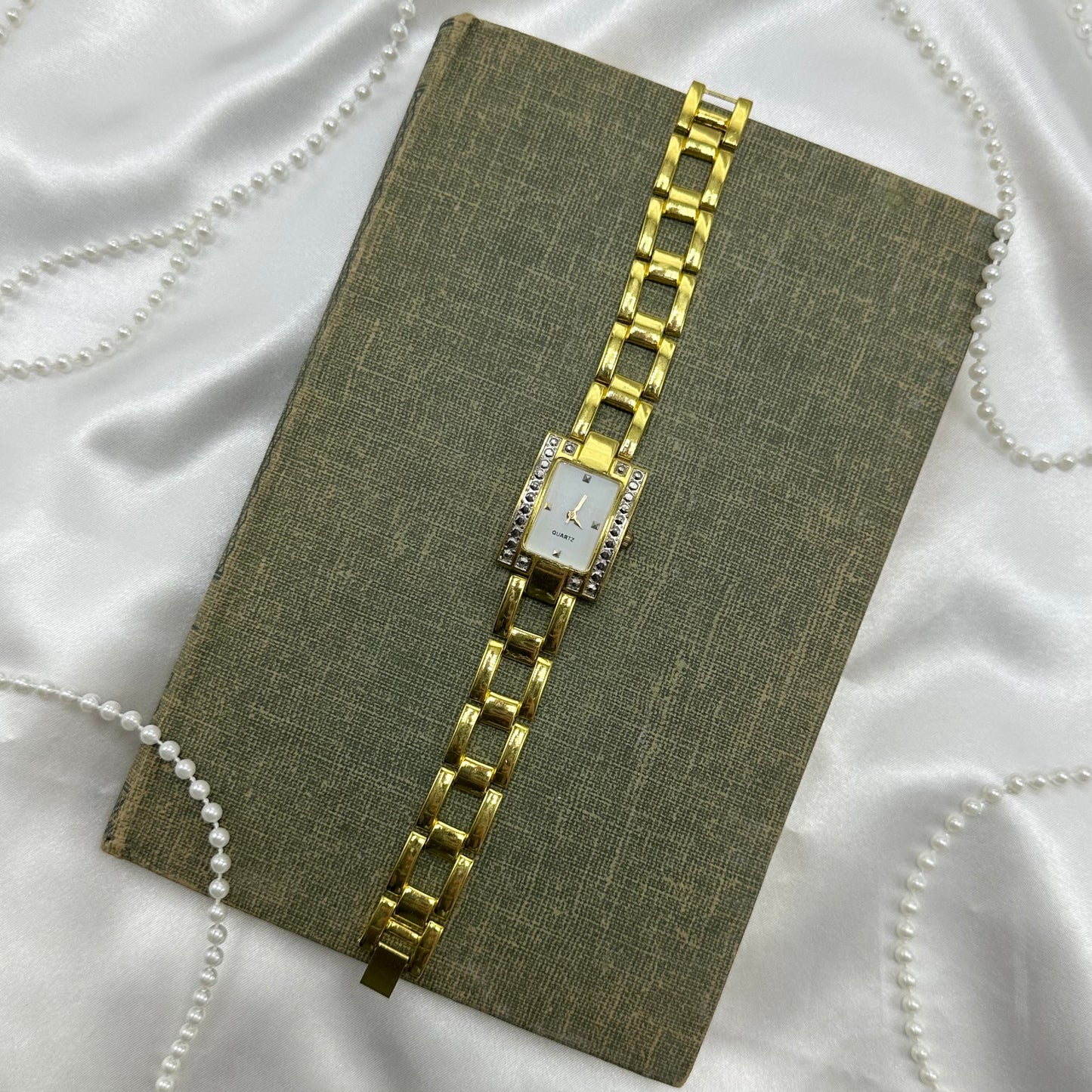 Chunky gold tone diamanté watch with quartz movement.