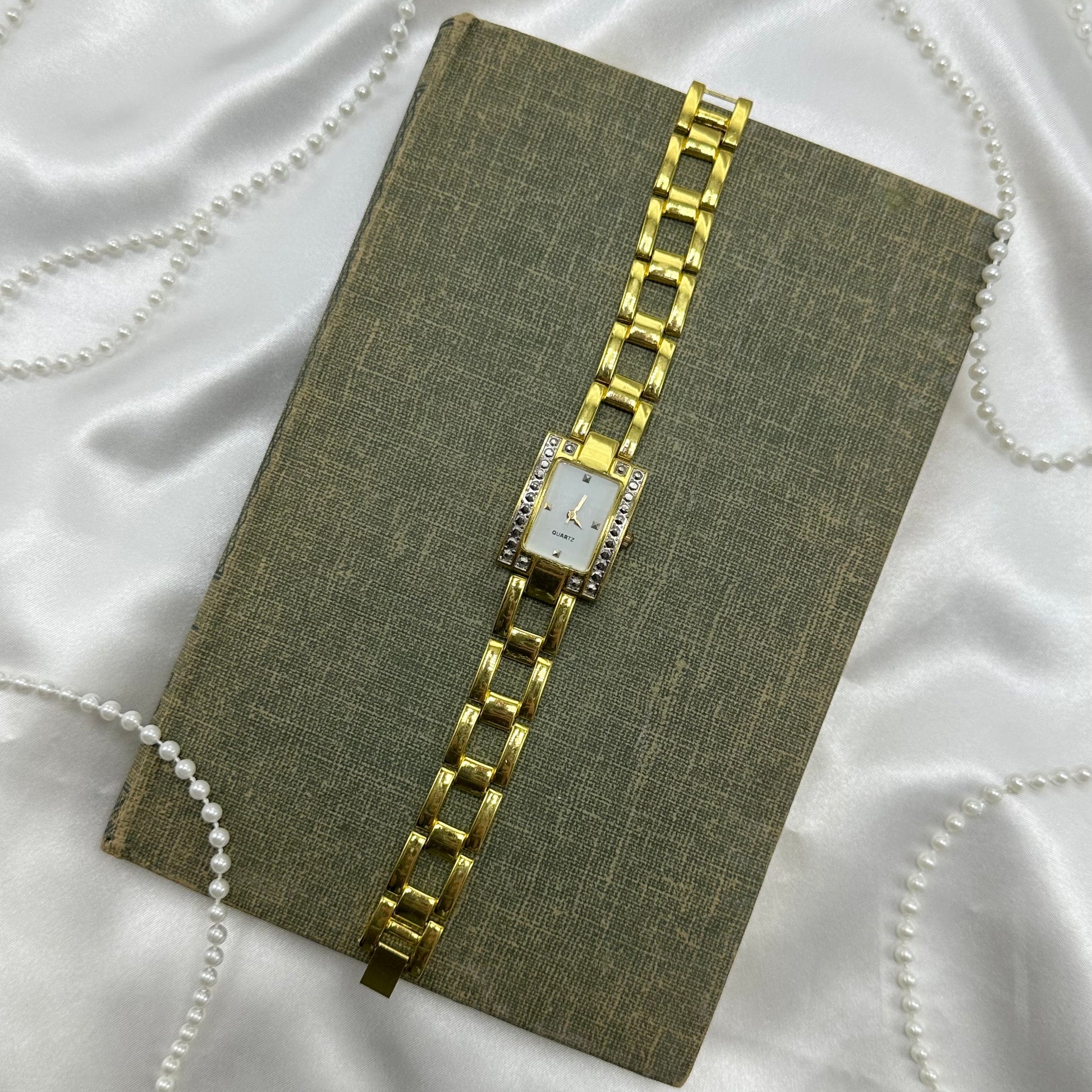 Chunky gold tone diamanté watch with quartz movement.