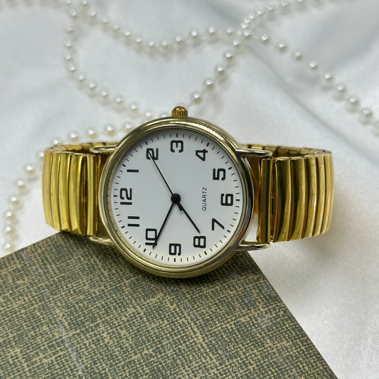 Classic gold tone watch with quartz movement.